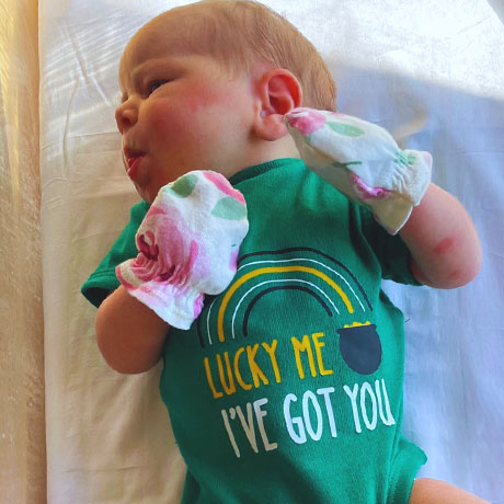 Newborn wearing St. Patrick's Day Onesie at The Christ Hospital Birthing Center