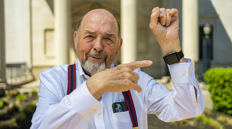 William Fryer points to his smartwatch