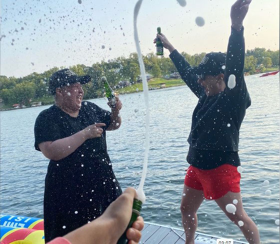 Leanne and Lauren pop champagne on a lake trip to celebrate successful treatment.