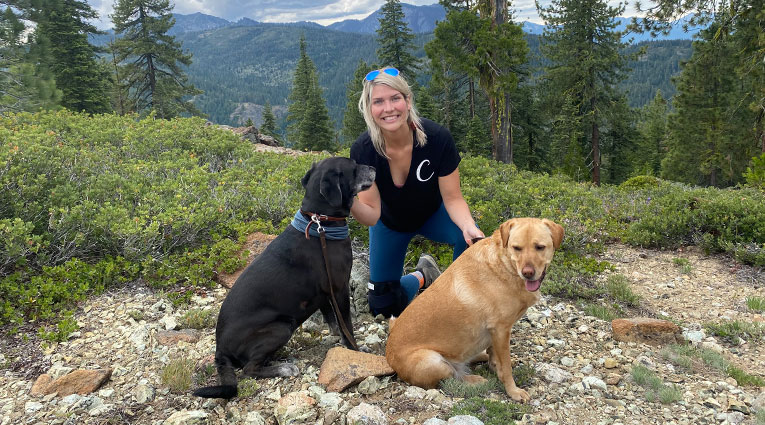 Cara wearing knee brace on hike with her dogs