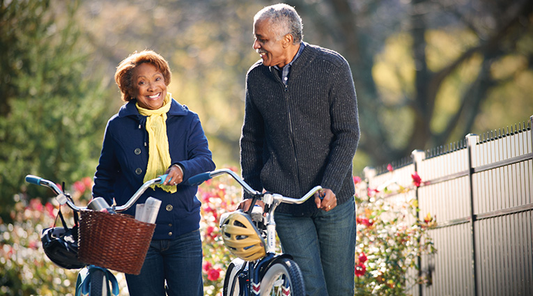 Couple walking outdoors with bicycles