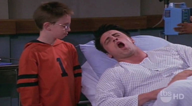 Screen capture of the character Joey in hospital bed on TV Show "Friends" 