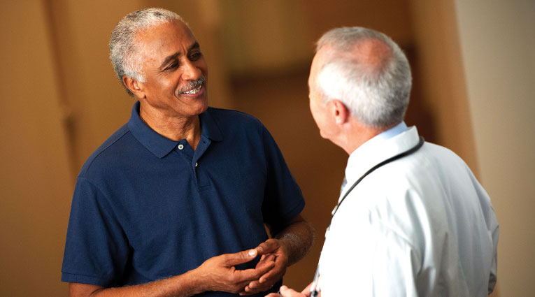 Older man talks with doctor