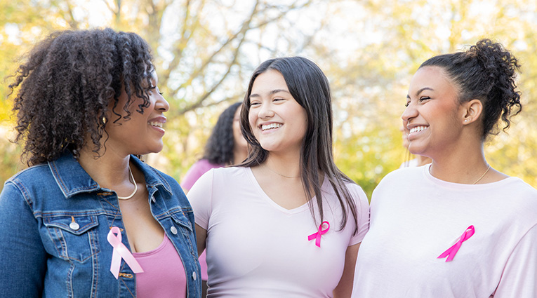 Young women showing support for breast cancer awareness