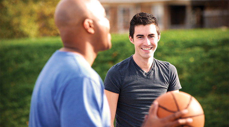 Two men playing basketball