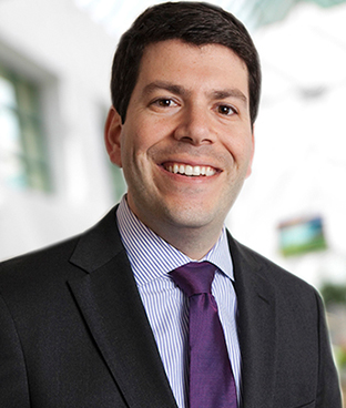 Dan Pelchovitz, MD, wearing a dark suit and purple tie.