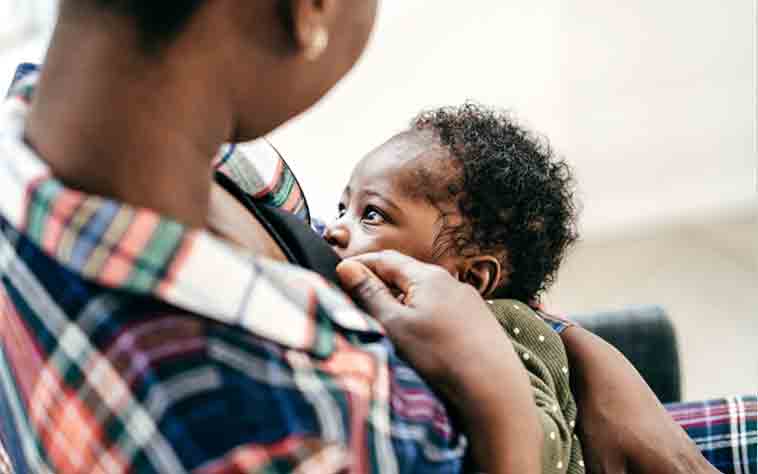 African American woman breasfeeding her baby