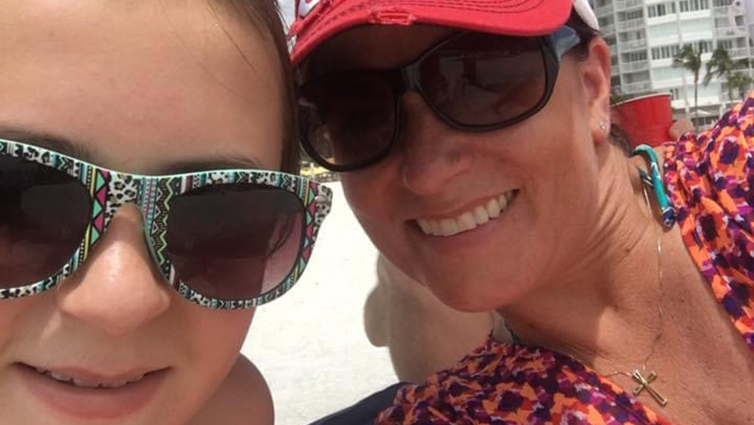 B105 radio personality Chelsie, wearing a pink hat the beach with her daughter, for her blog about water safety.