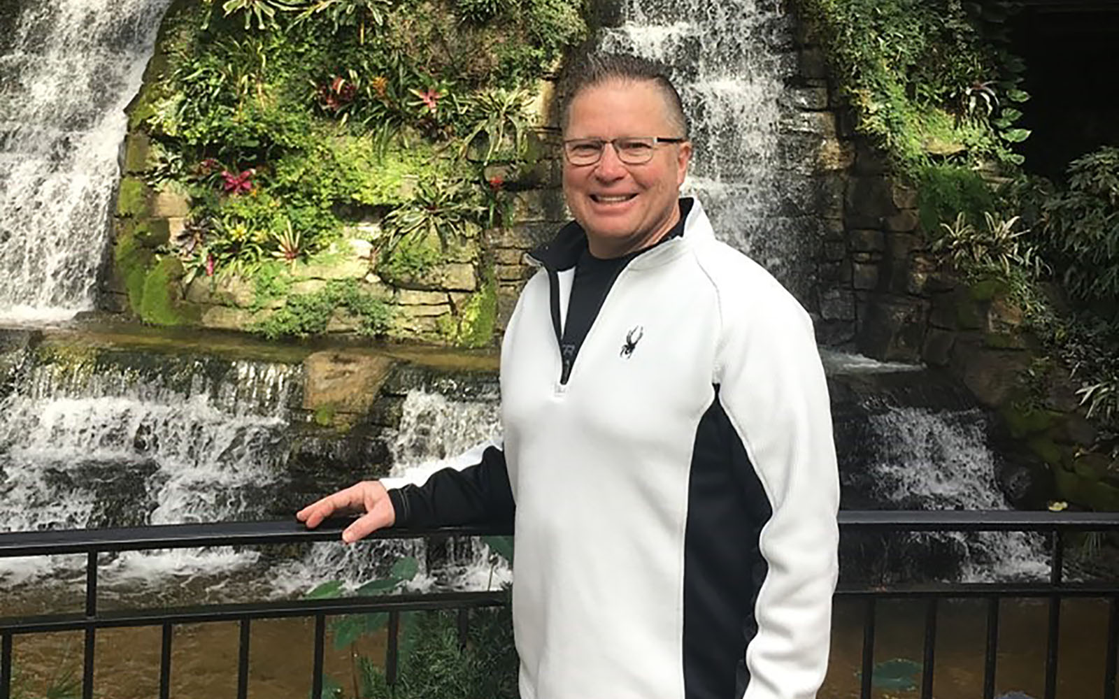 Darrin Steinmann standing in front of a waterful, as he shares his story about beating prostate cancer.