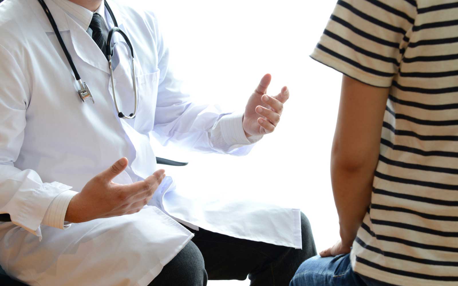 doctor talking to young patient