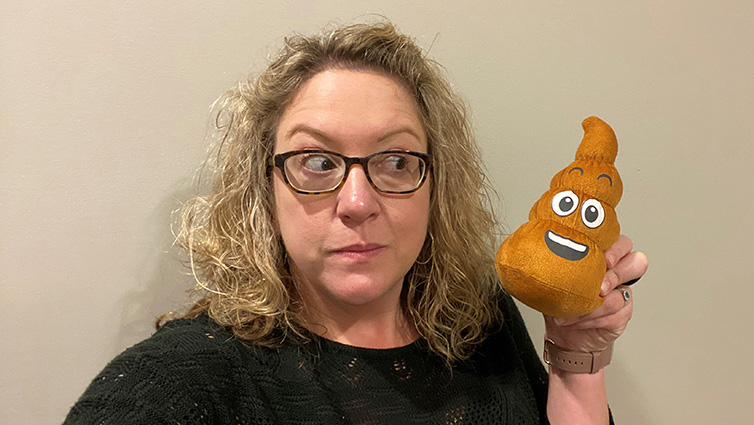 Q102 radio personality holding a stuffed emoji toy for her blog about colonoscopies.