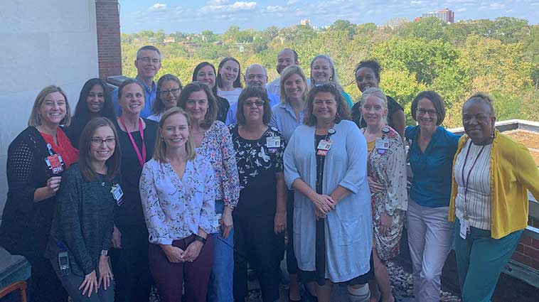 Palliative Care team at The Christ Hospital standing on a rooftop. 