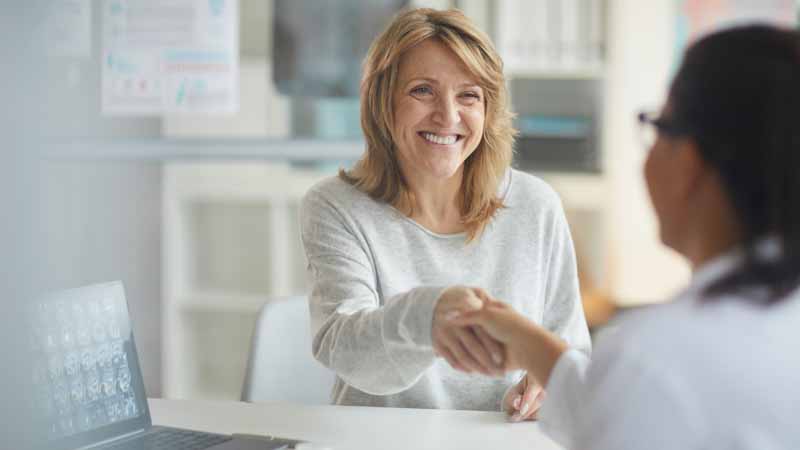 Women shakes hands with her physician at an appointment.