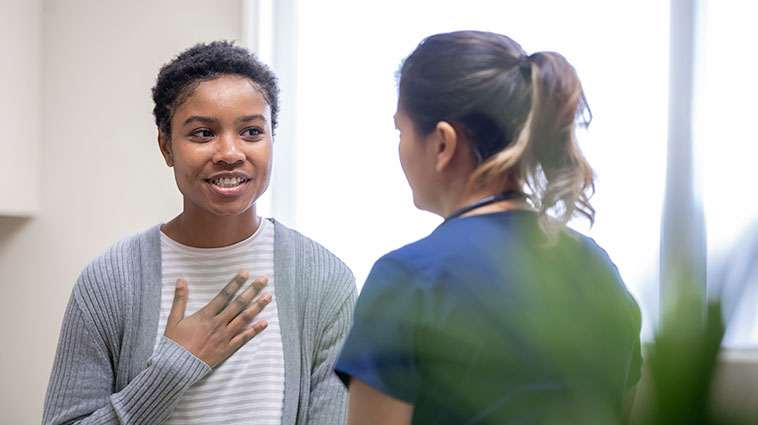 Female patient talks with female healthcare worker about pelvic floor disorders.