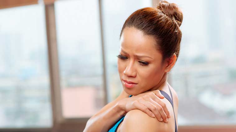 Woman experience shoulder pain, possibly related to arthritis.