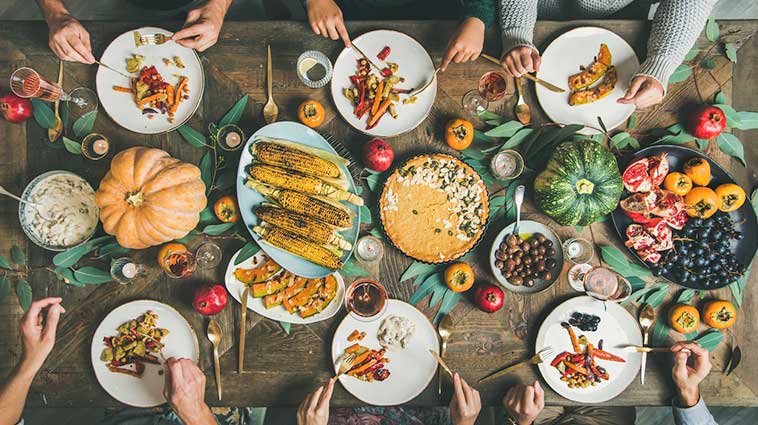 Family-style meal and plates of vegetables and healthy food.