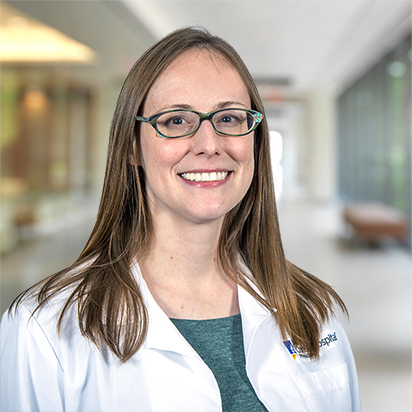 Emily Neaville, MD, wearing a white lab coat.