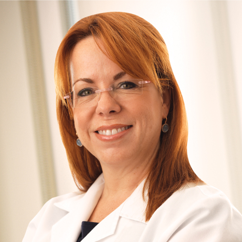 Dr. Janice Rafferty, colorectal surgeon, wearing a white lab coat. 