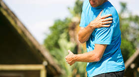 Man running with shoulder pain