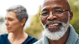 Older African American man smiling after recovering from stroke. 