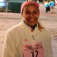 Breast cancer survivor running marathon.