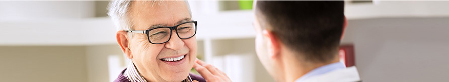 Happy man and his doctor discussing treatment.