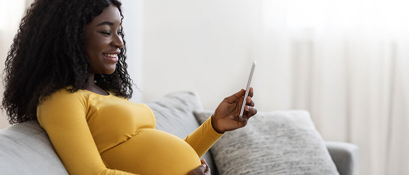 Pregnant woman looking at cell phone