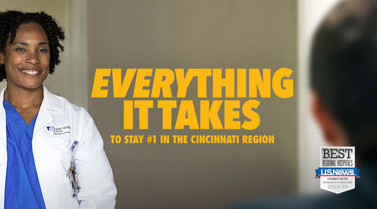 Healthcare worker with graphic overlay Everything It Takes to stay #1 in the Cincinnnati Region