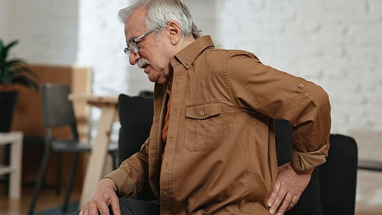 Older man experiencing low back pain