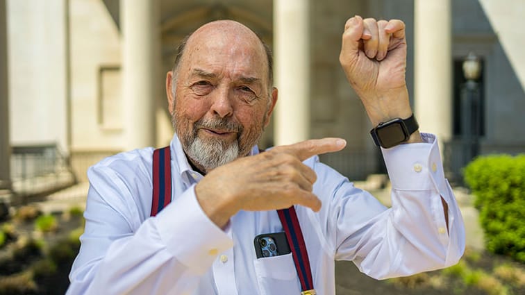William Fryer points to his smartwatch