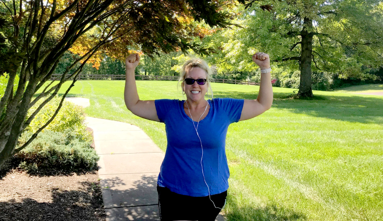 Q102 radio personality Jennifer Fritsch walking outside with headphones on for fitness blog with The Christ Hospital