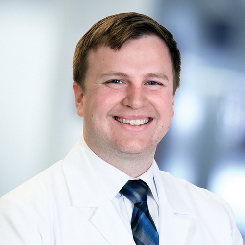 Bryan Grove, MD, wearing a white lab coat.